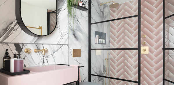 A beautifully designed art deco tile bathroom featuring geometric shaped tiles in black and white color scheme, a sleek vanity, and a stylish mirror.