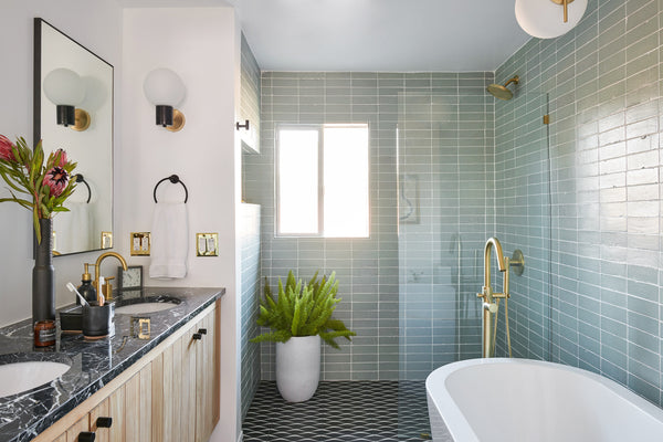 Mid-Century Modern bathroom design featuring subway tiles, oak vanity with black countertop, and black geometric pattern floor tiles from Tile Lab Green Brook NJ
